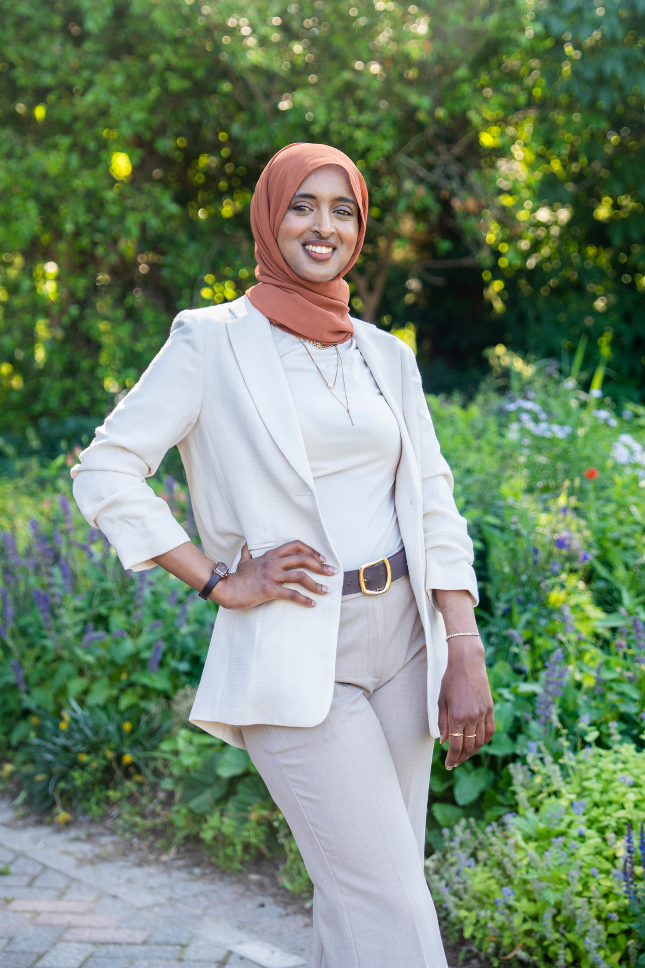 Salimah Hussien in a cream suit, professional speaker portrait